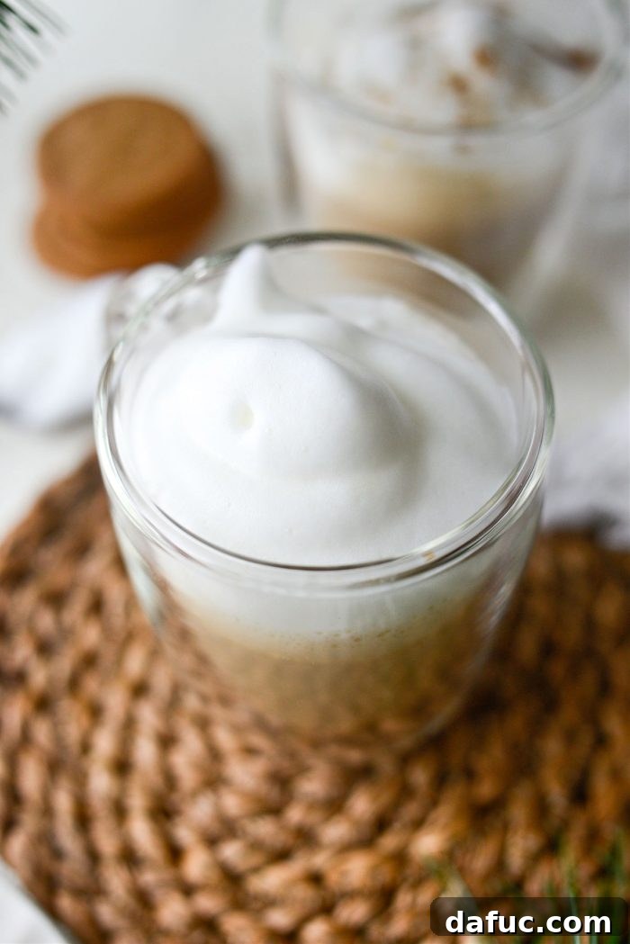 Spoon milk foam over the latte