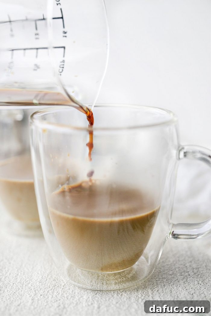 Adding espresso to eggnog in a mug