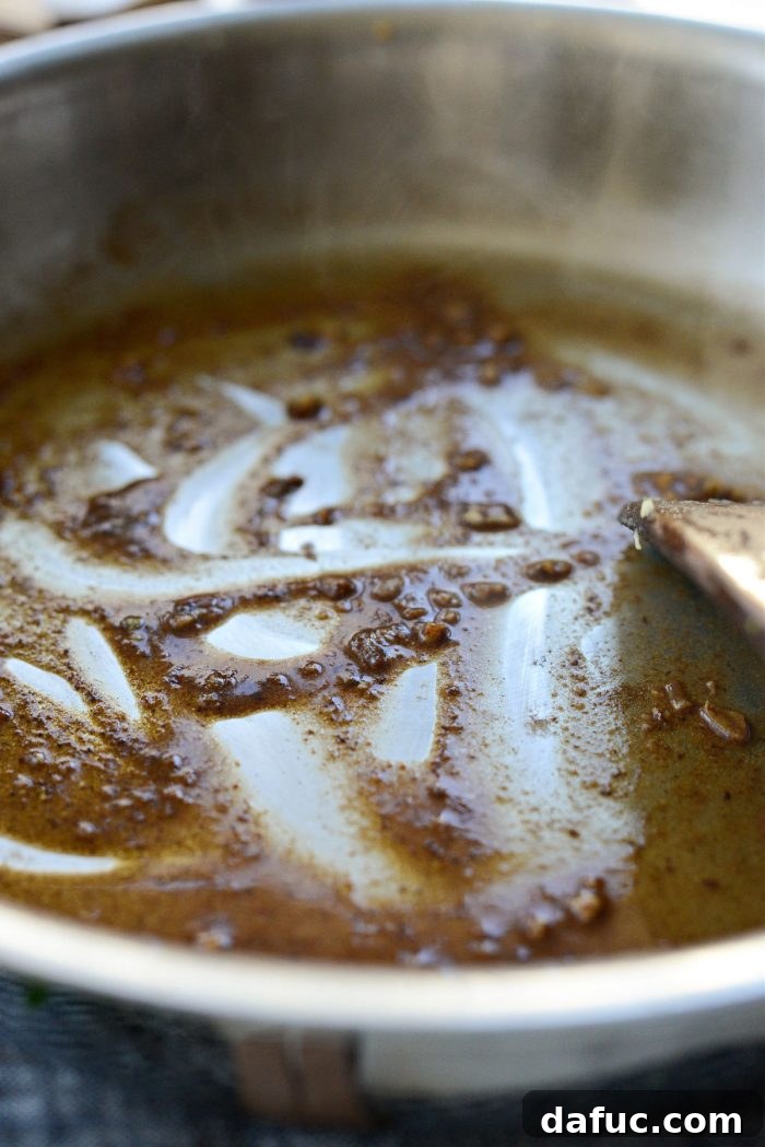 Decadent Maple Bourbon Bacon Brussels 13 Bourbon reducing in the pan, creating a rich base for the glaze.
