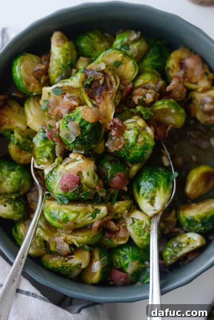 Decadent Maple Bourbon Bacon Brussels 19 Maple Bourbon Bacon Brussels Sprouts presented on a platter, ready to be served as a side dish.