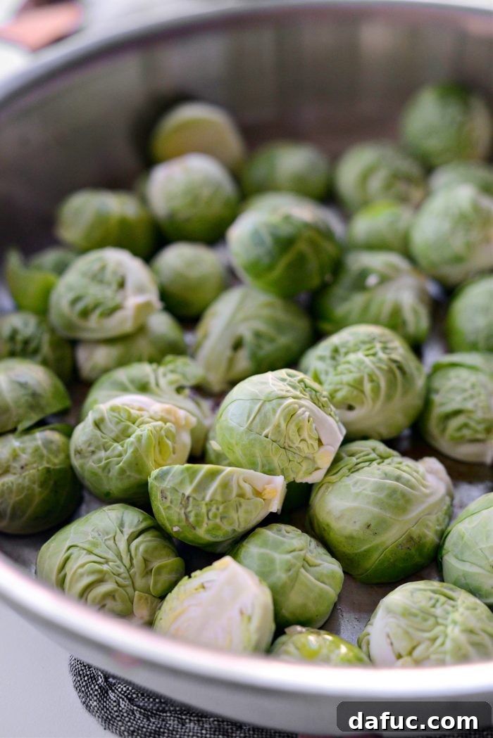 Decadent Maple Bourbon Bacon Brussels 8 Halved Brussels sprouts placed cut-side down in a single layer in a skillet, then covered to cook.