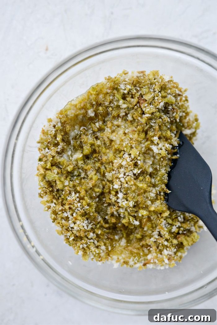 The Ultimate Jalapeño Popper Dip 14 Combining crispy jalapeño crumbs, panko breadcrumbs, and melted butter in a bowl