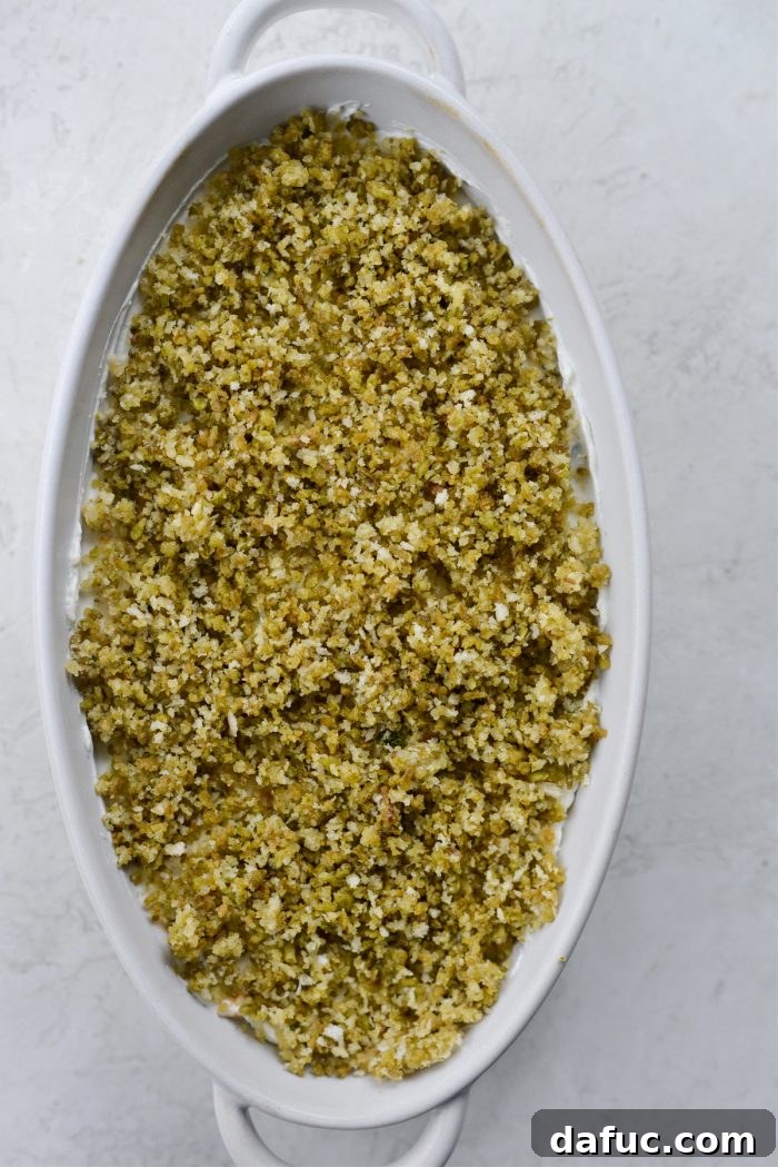 The Ultimate Jalapeño Popper Dip 15 Jalapeño dip in baking dish topped with crispy jalapeño and panko mixture