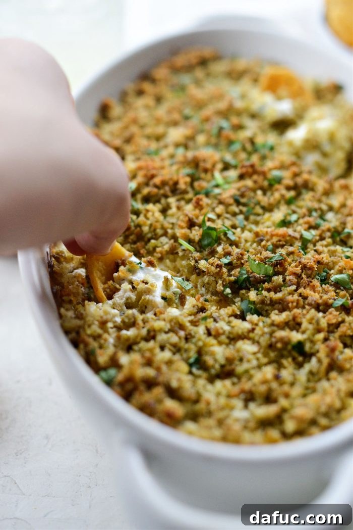 The Ultimate Jalapeño Popper Dip 18 Jalapeño Popper Dip ready to be scooped and enjoyed