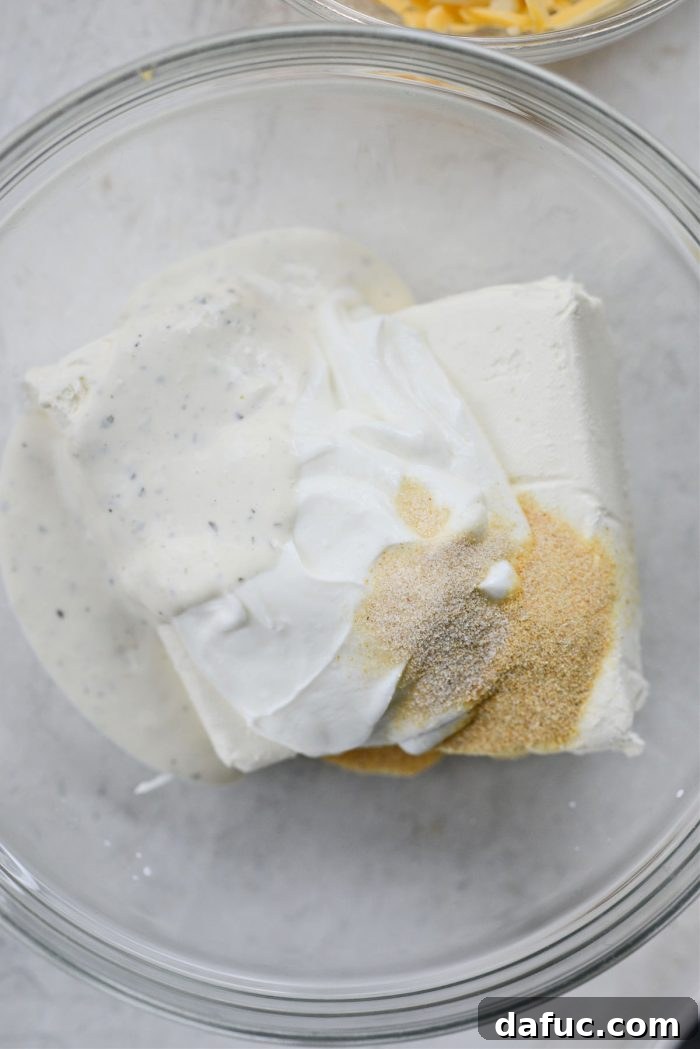 The Ultimate Jalapeño Popper Dip 5 Bowl with softened cream cheese, Greek yogurt, ranch dressing, garlic powder, and onion powder