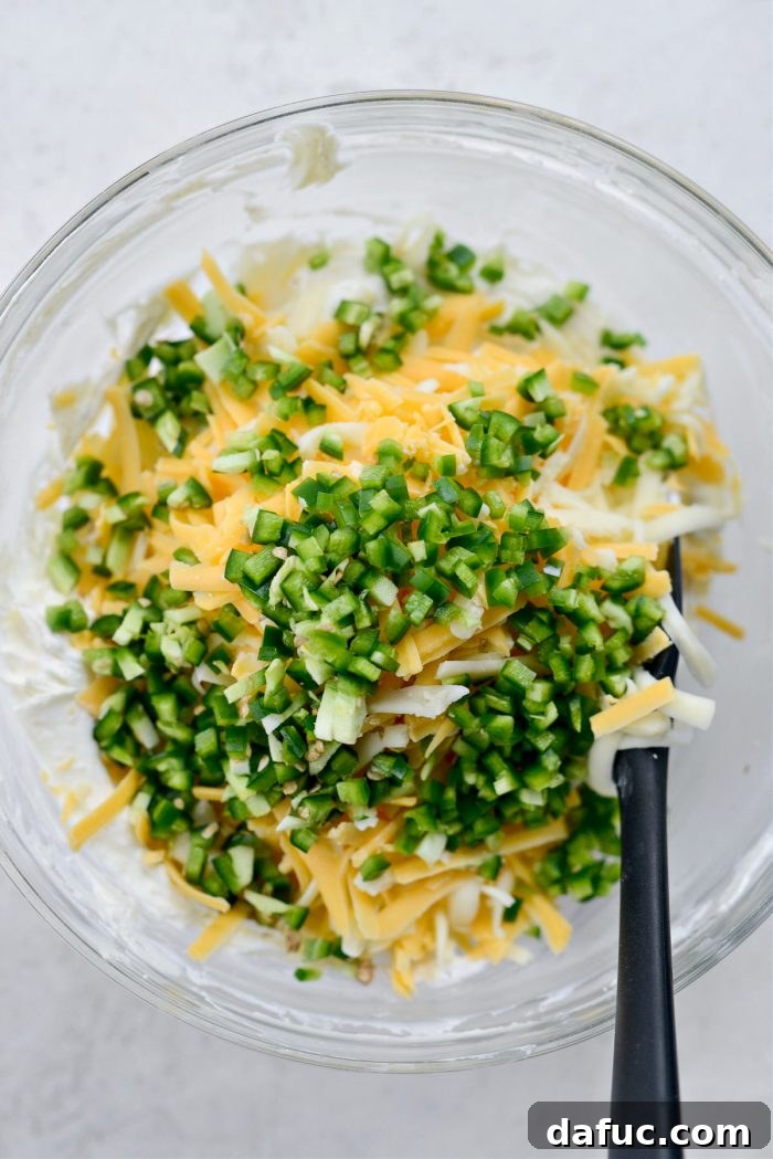 The Ultimate Jalapeño Popper Dip 7 Shredded cheddar cheese, Monterey Jack cheese, and diced jalapeños added to the creamy dip base