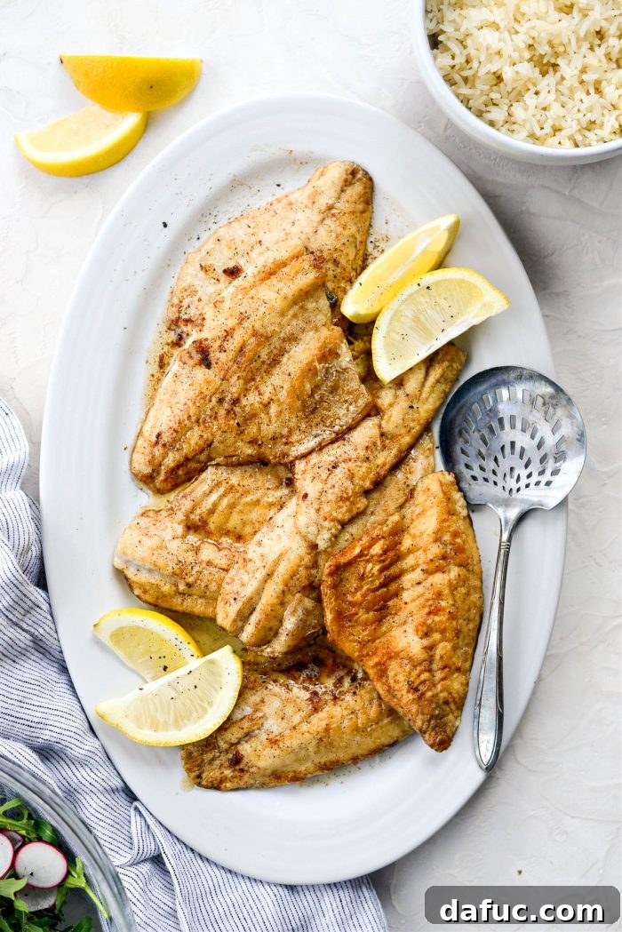 Pan-Seared Perch with Lemon Brown Butter 15 Lemon Brown Butter Perch on a platter with lemon slices