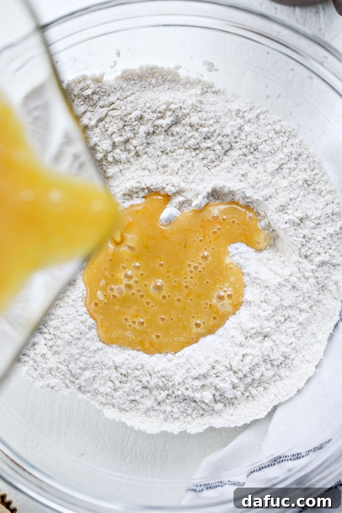 Fragrant Orange Cardamom Gems 13 Pouring wet ingredients into dry ingredients