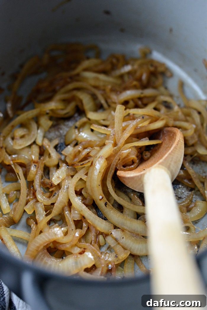 Golden Roasted Parsnip Puree 11 Close-up of golden-brown sautéed onions in a Dutch oven.