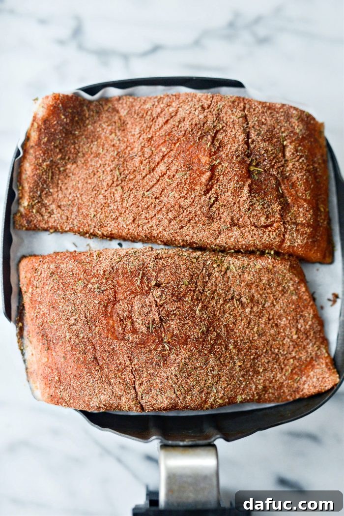 Spicy Salmon Street Tacos 13 Salmon fillets placed in an air fryer basket on parchment paper