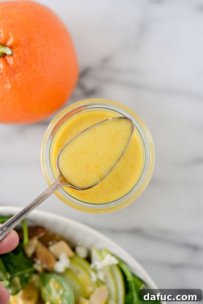 Citrus Vinaigrette in a small bowl with salad in background