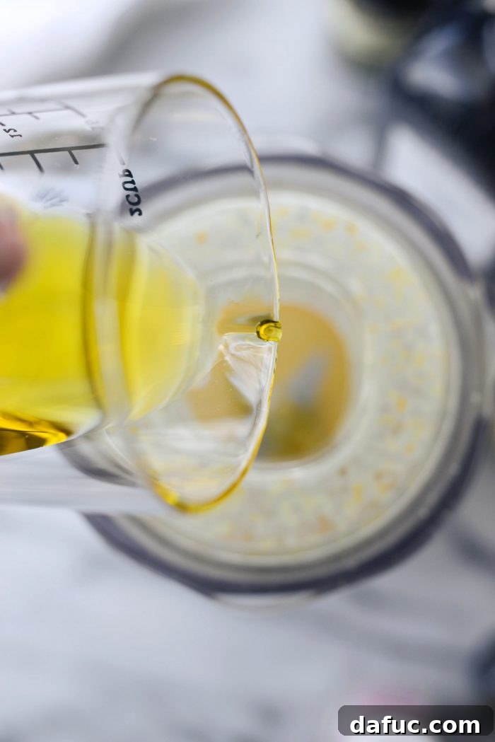 With blender on, pouring in olive oil
