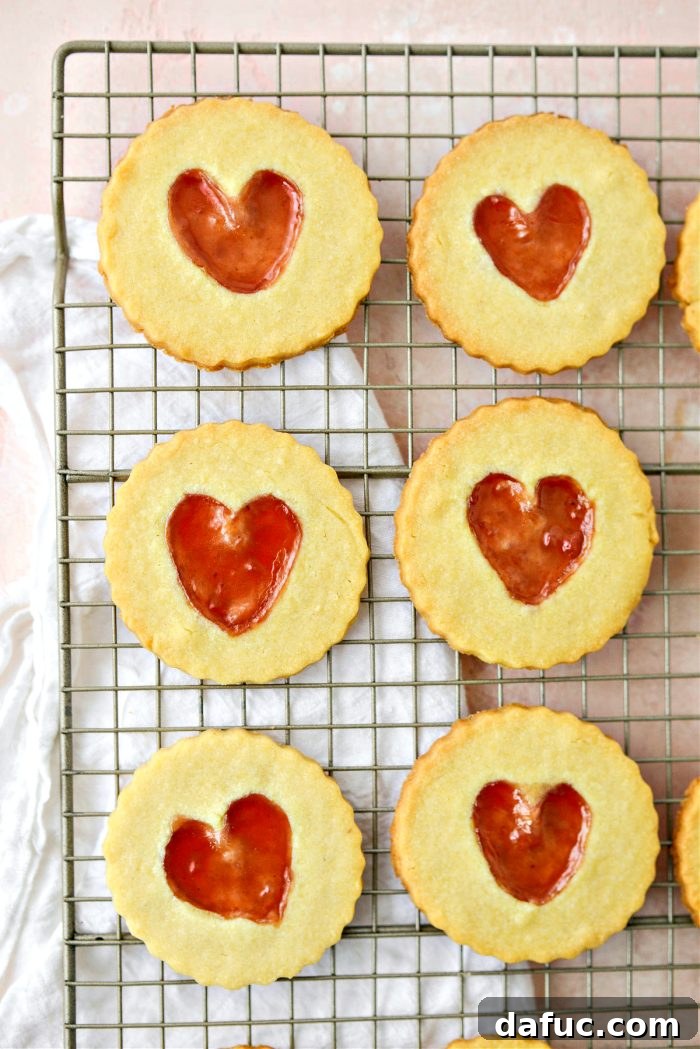 Jam Filled Butter Heart Cookies 18 Jam Heart Butter Cookies gently placed on a wire rack to cool completely after baking, ensuring crispness.