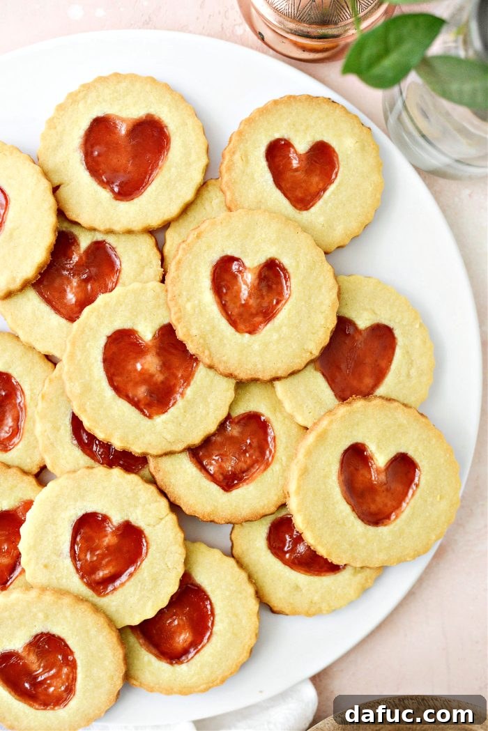 Jam Filled Butter Heart Cookies 19 A delightful presentation of Jam Heart Butter Cookies served with a refreshing glass of cold milk, ready for enjoyment.
