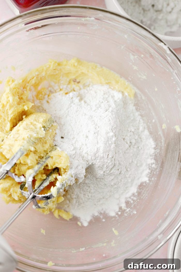 Jam Filled Butter Heart Cookies 8 The smoothly combined cookie dough after all wet ingredients have been thoroughly mixed in, showcasing a uniform yellow color.