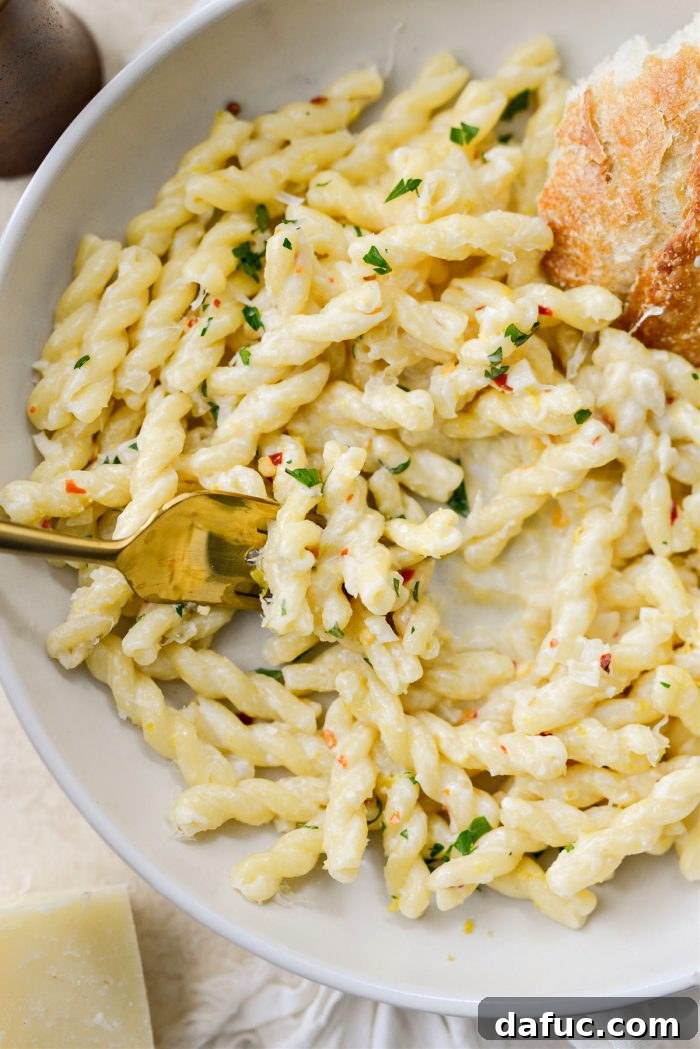 Velvety Lemon Parmesan Pasta 19 Close-up shot of Creamy Lemon Parmesan Pasta in a bowl, ready to be enjoyed