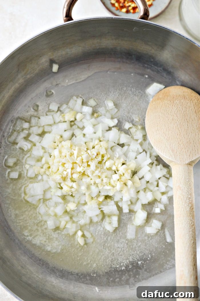 Velvety Lemon Parmesan Pasta 8 Finely diced onions and minced garlic with a pinch of salt sautéing in a skillet