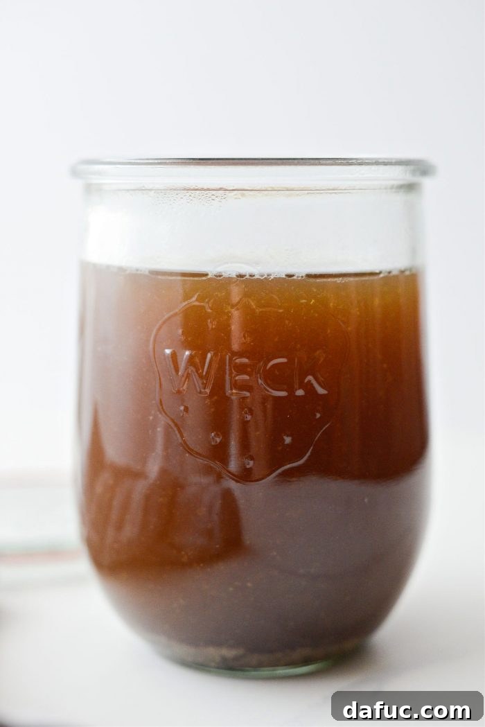 Fall-Off-The-Bone Slow Cooker Chicken 13 Four cups of rich chicken broth or stock in a glass jar