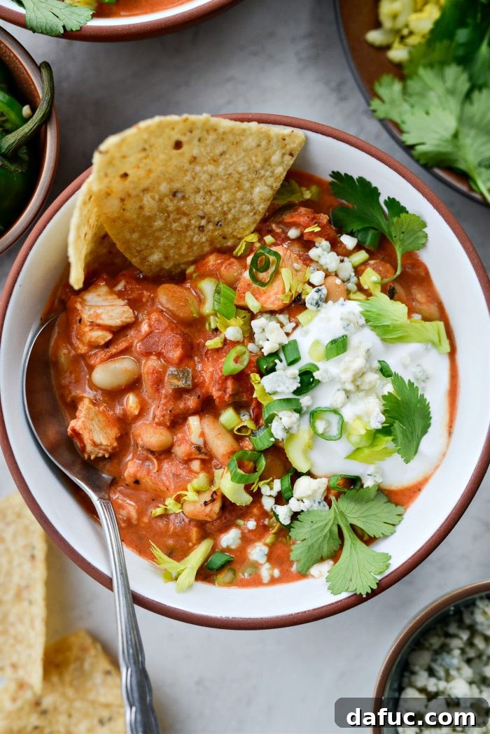 Zesty Buffalo Chicken Chili 2 Delicious Buffalo Chicken Chili served in a bowl with toppings