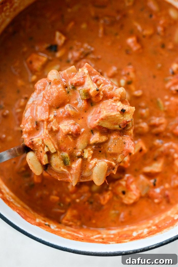 Zesty Buffalo Chicken Chili 17 Ladle of Buffalo Chicken Chili being poured into a bowl