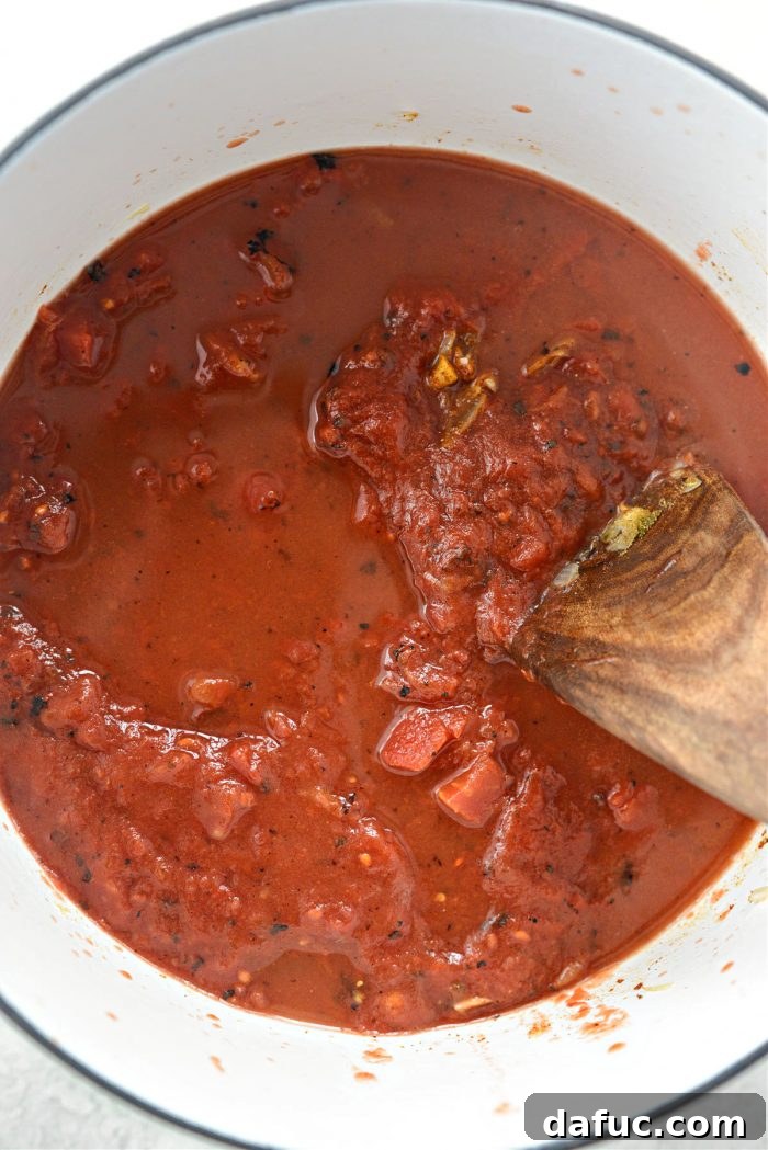 Zesty Buffalo Chicken Chili 10 Crushed tomatoes, chicken stock, and Frank's Red Hot sauce added to the pot