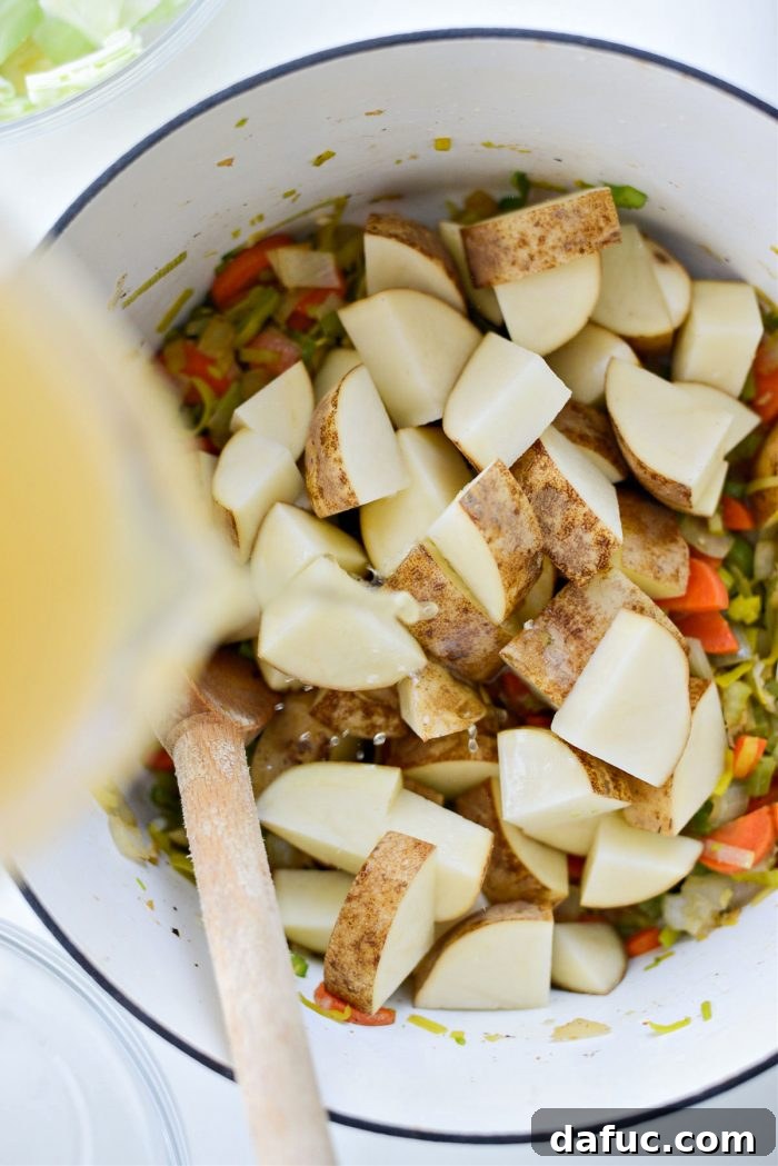 Add potatoes, chicken stock, and water to the pot