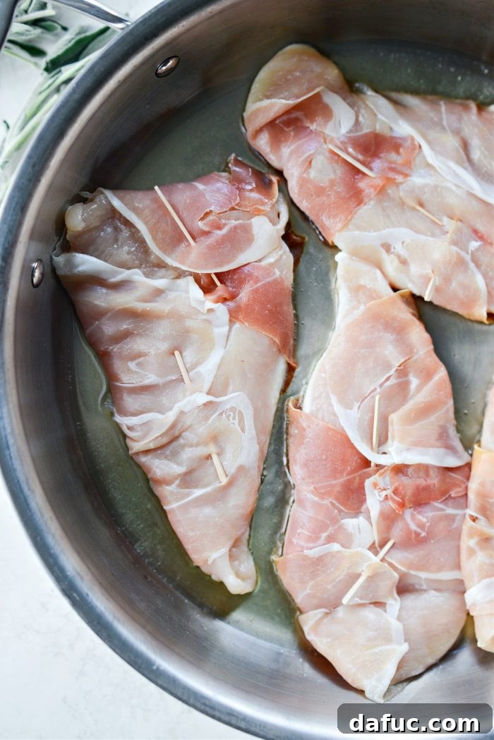 Searing garlic prosciutto sage chicken, sage side down