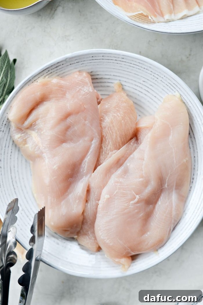 Sliced chicken breast halves ready for pounding
