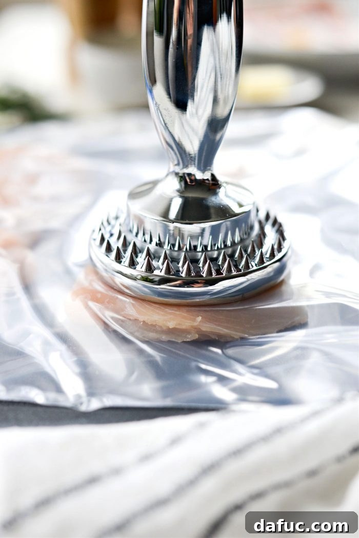 Pounding chicken breast halves thin for even cooking