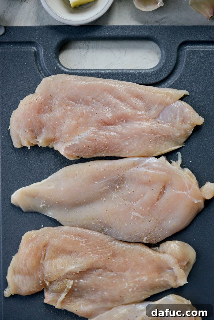 Seasoning chicken breasts with salt and pepper