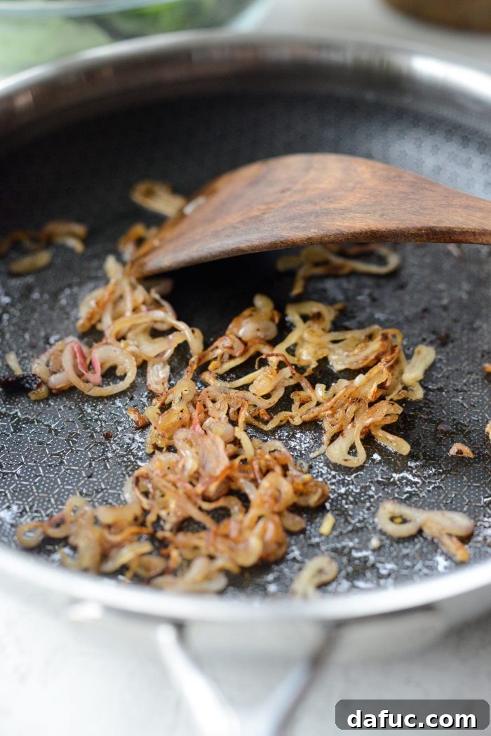 Fried shallots draining on a paper towel