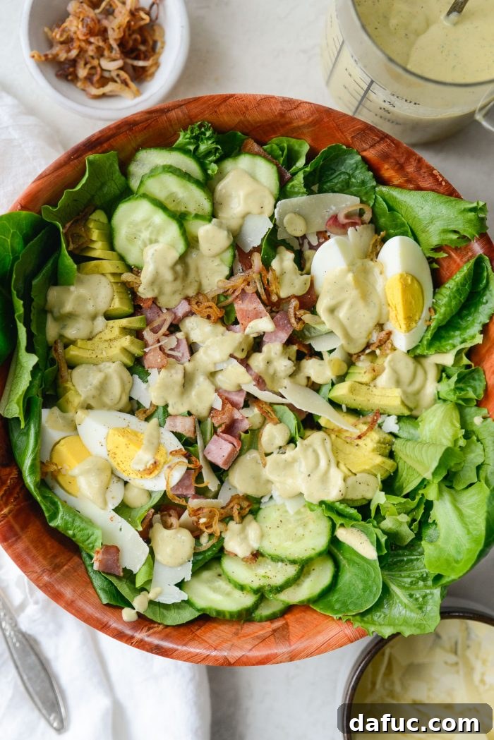 Drizzling avocado ranch dressing over Shoreline Salad