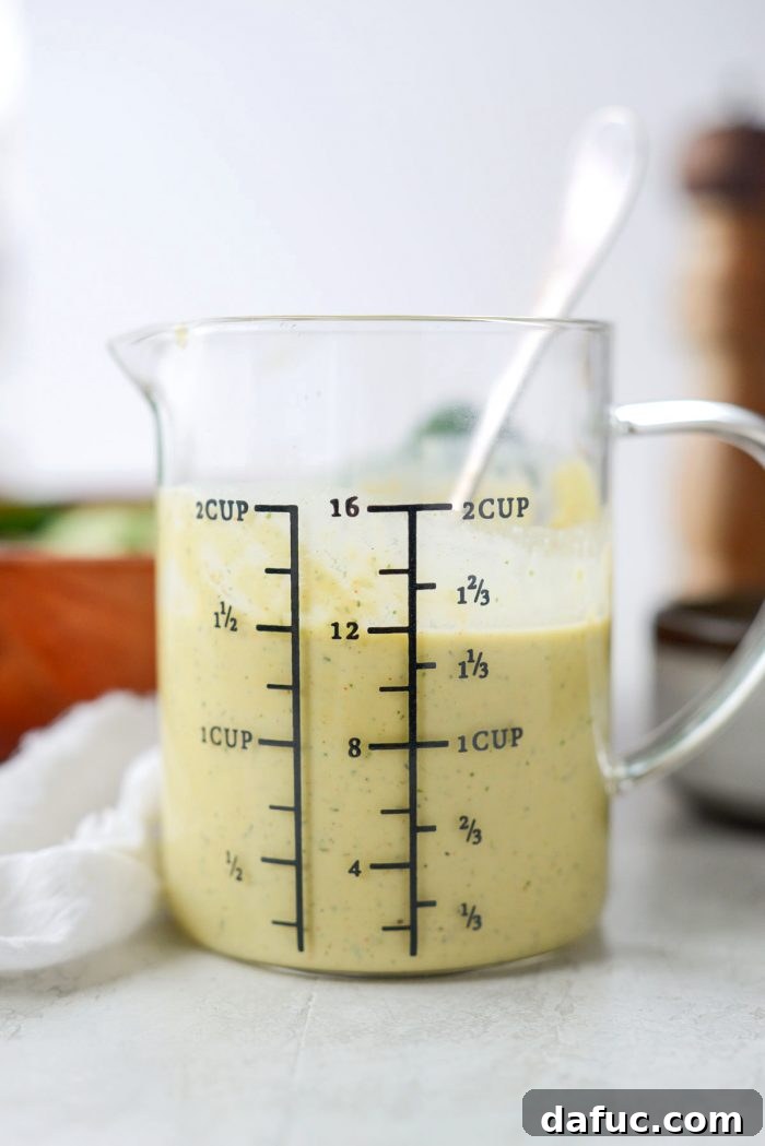 Blended avocado ranch dressing in a blender cup