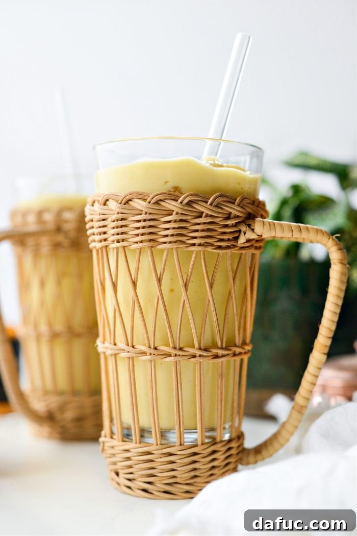 Liquid Sunshine Mango 13 A beautifully presented Golden Mango Smoothie in a glass, ready for enjoyment.
