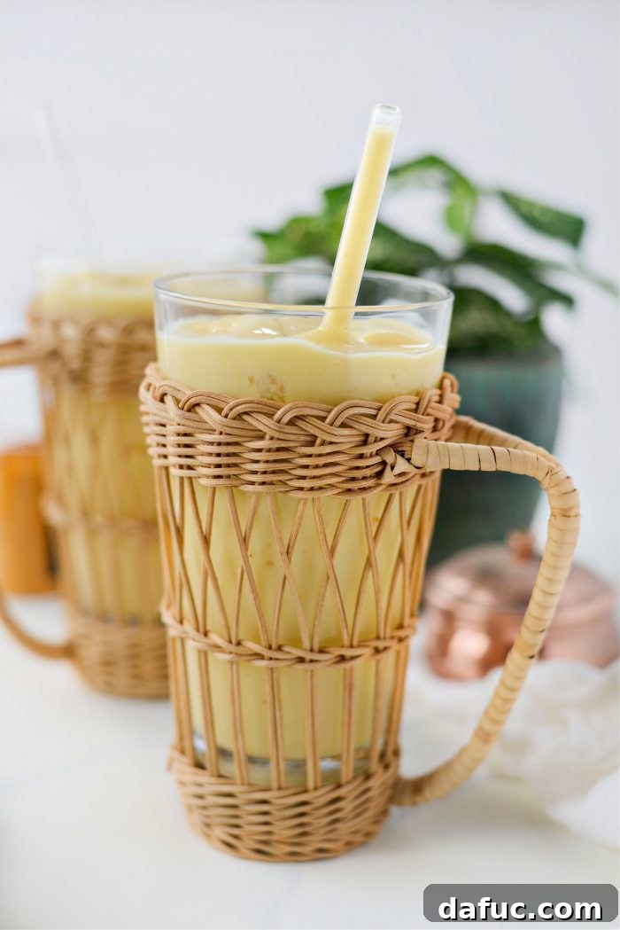 Liquid Sunshine Mango 15 Another beautiful shot of the Golden Hour Mango Smoothie in a glass, with a vibrant, inviting appearance.