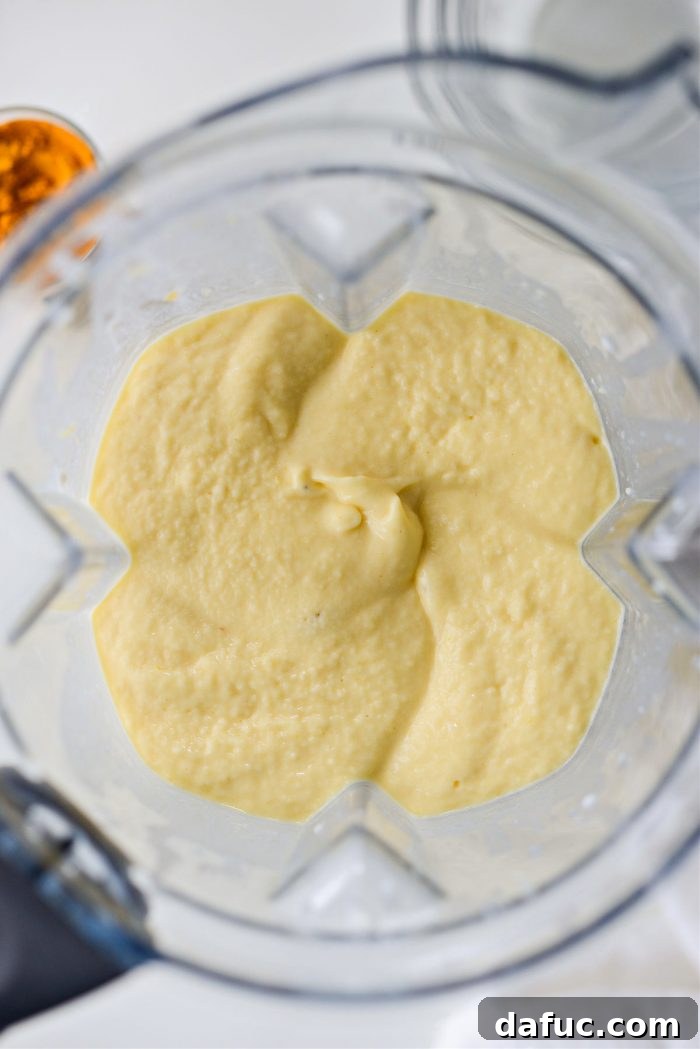 Liquid Sunshine Mango 10 The blended Golden Hour Mango Smoothie, smooth and creamy, inside the blender jar.