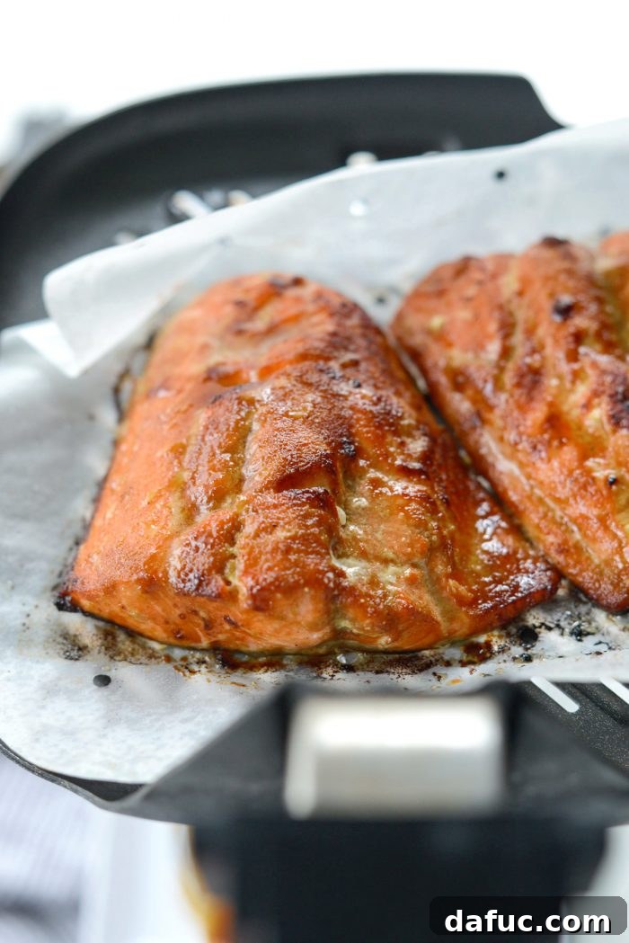 Air Fryer Sriracha Salmon garnished with green onions and sesame seeds