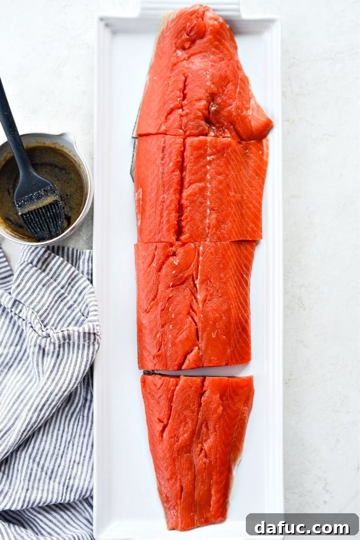 Salmon filet being portioned into individual servings