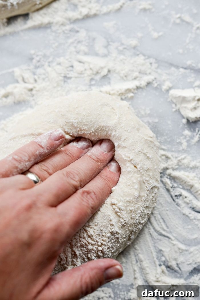 Stretching pizza dough into a circular shape for the crust