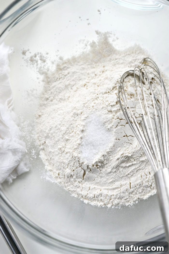 Dry ingredients for pizza dough measured in a mixing bowl