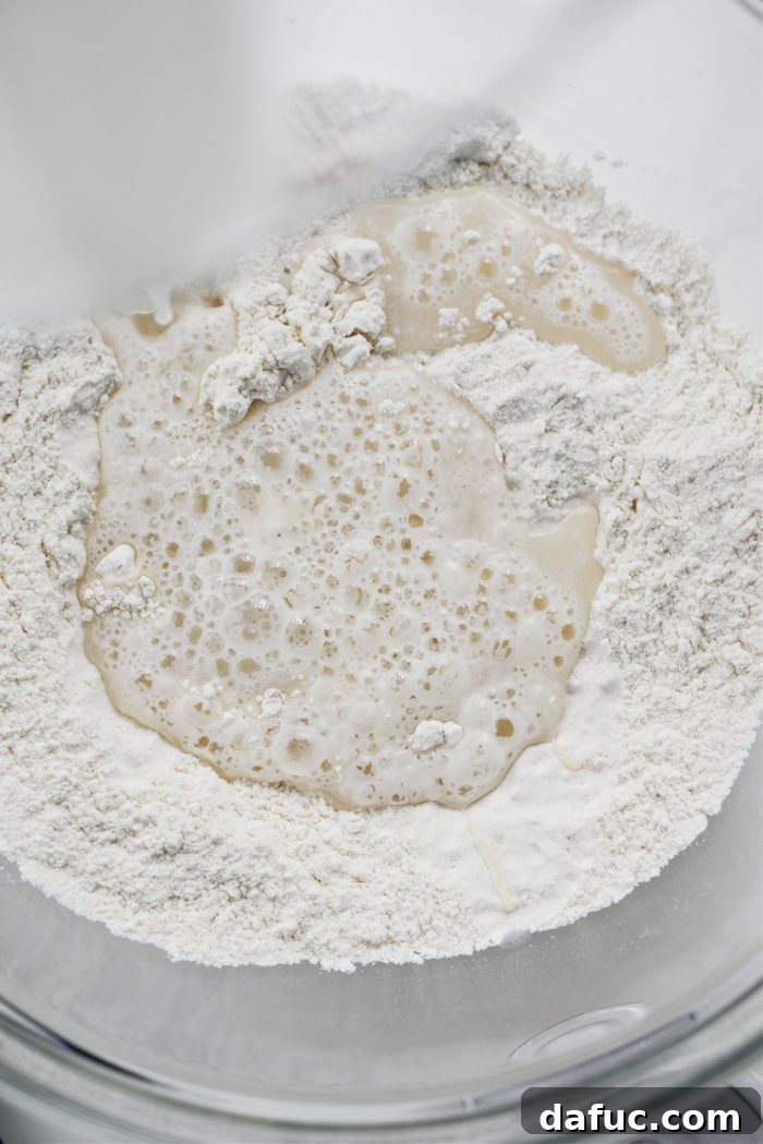 Pouring yeast water into the dry flour mixture