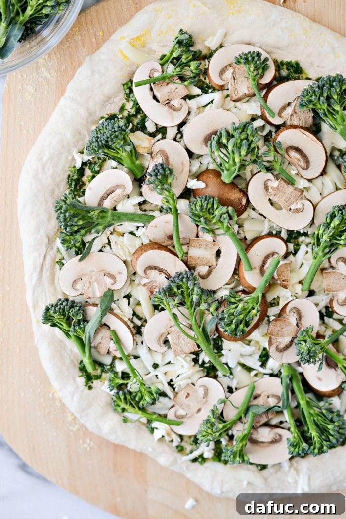 The final layer of mozzarella cheese sprinkled over the toppings