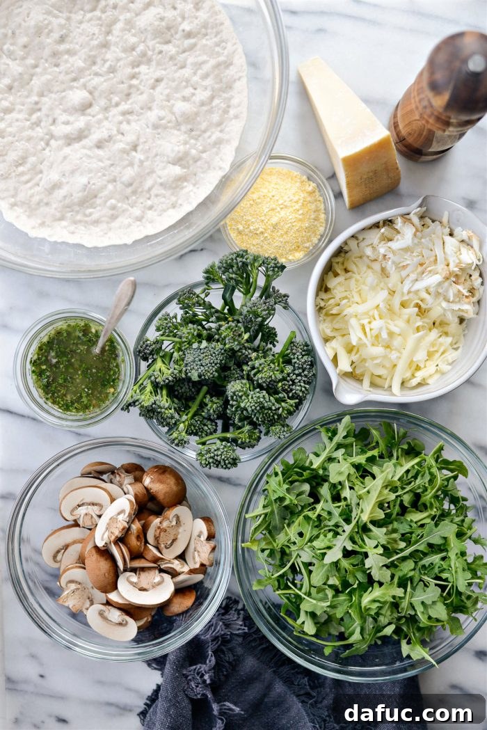 A selection of fresh ingredients for Green Forest Pizza, including mushrooms, broccolini, and cheeses
