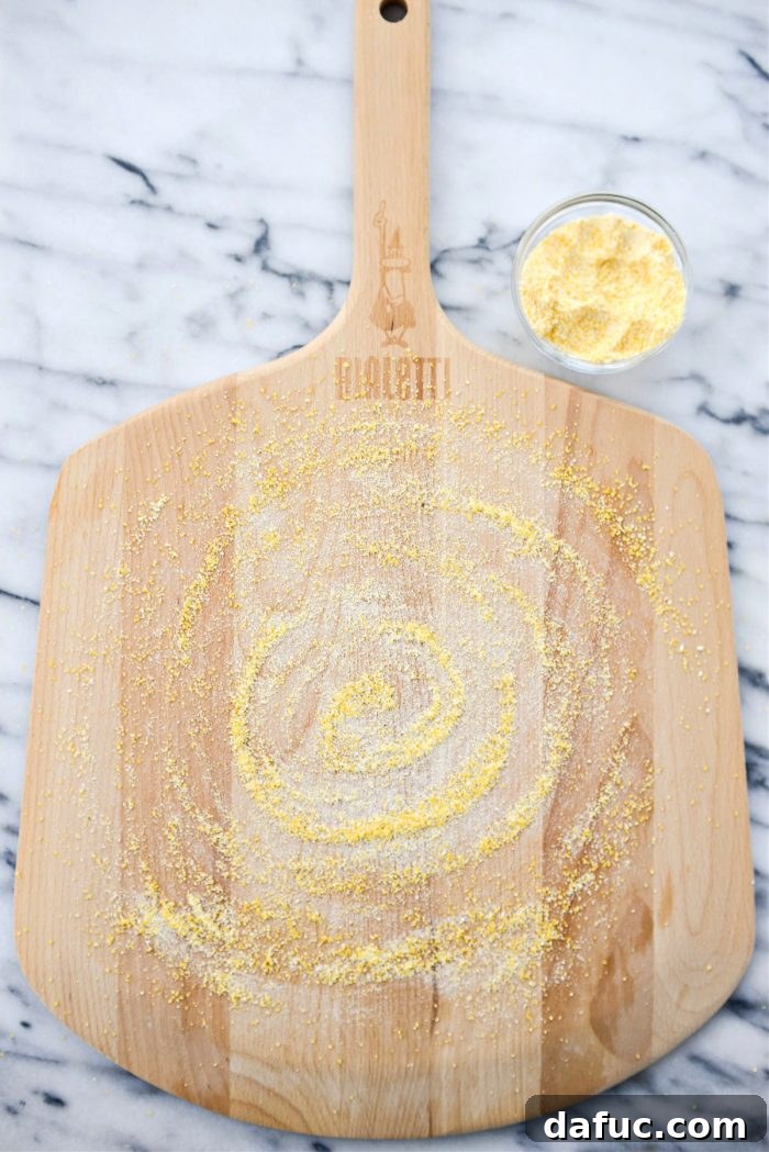 Pizza peel generously coated with cornmeal, ready for dough