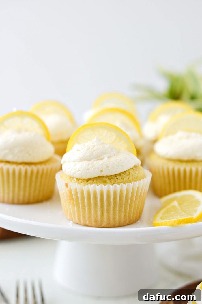 Tangy Lemon Cupcakes with Velvety Frosting 20 Decorated lemon cupcakes with lemon buttercream frosting, garnished with lemon slices and sparkling sugar