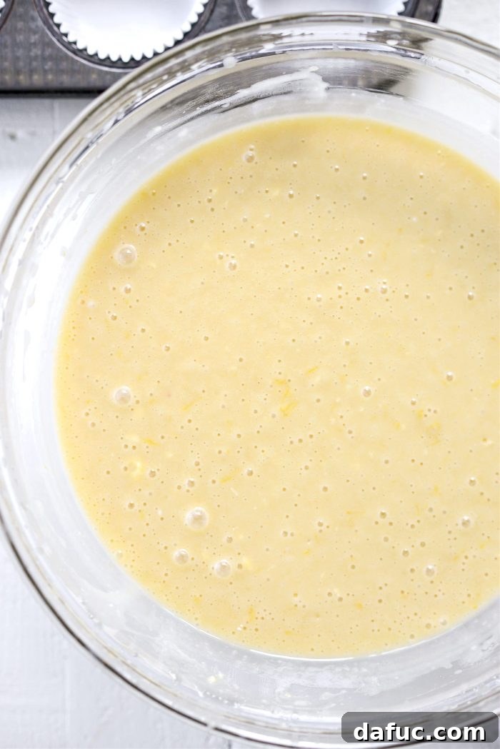 Tangy Lemon Cupcakes with Velvety Frosting 8 Cake batter being mixed in a stand mixer until just combined, showing a smooth texture