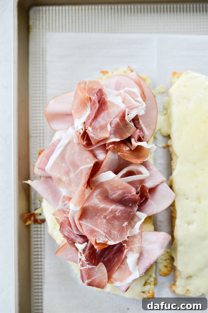 Old World Italian Sub 12 Bottom half of the focaccia sandwich layered with ham and prosciutto.