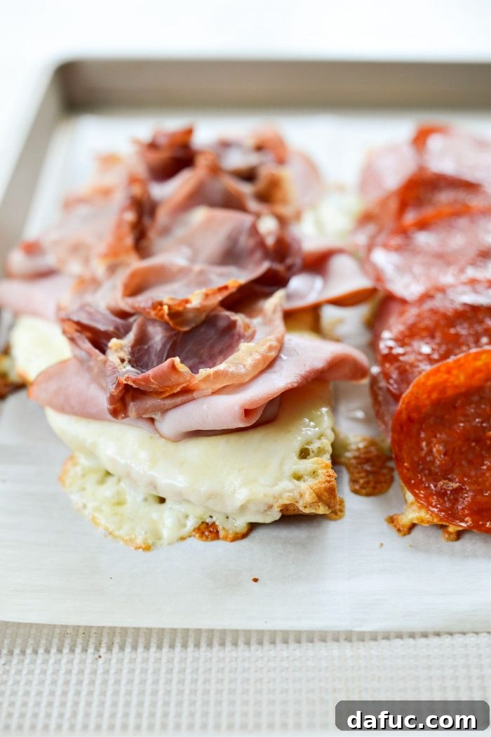 Old World Italian Sub 14 Both toasted focaccia halves, one with ham and prosciutto, the other with salami, soppressata, and pepperoni, fresh out of the oven.