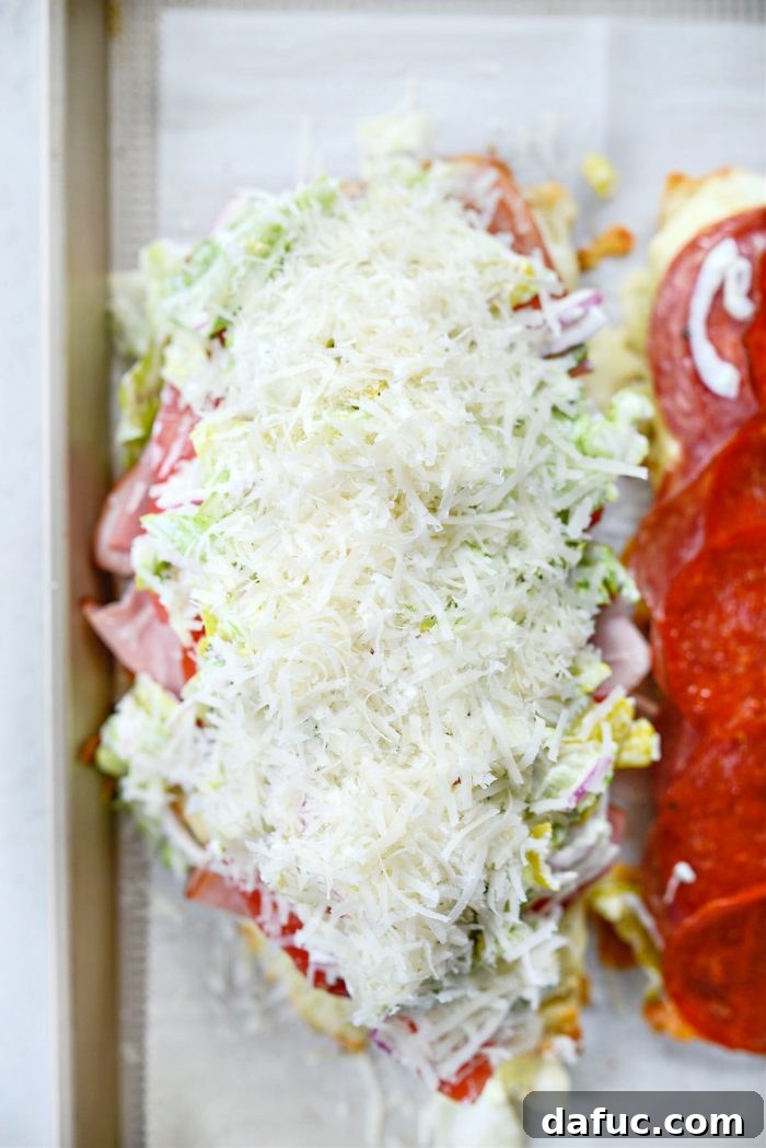 Old World Italian Sub 17 A large amount of freshly grated Parmesan cheese being sprinkled over the grinder salad.