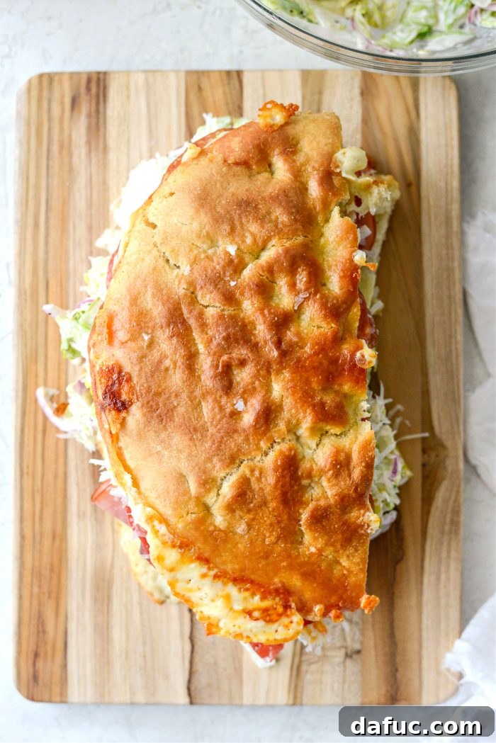 Old World Italian Sub 18 The top half of the sandwich being placed onto the bottom half, completing the Italian Grinder.